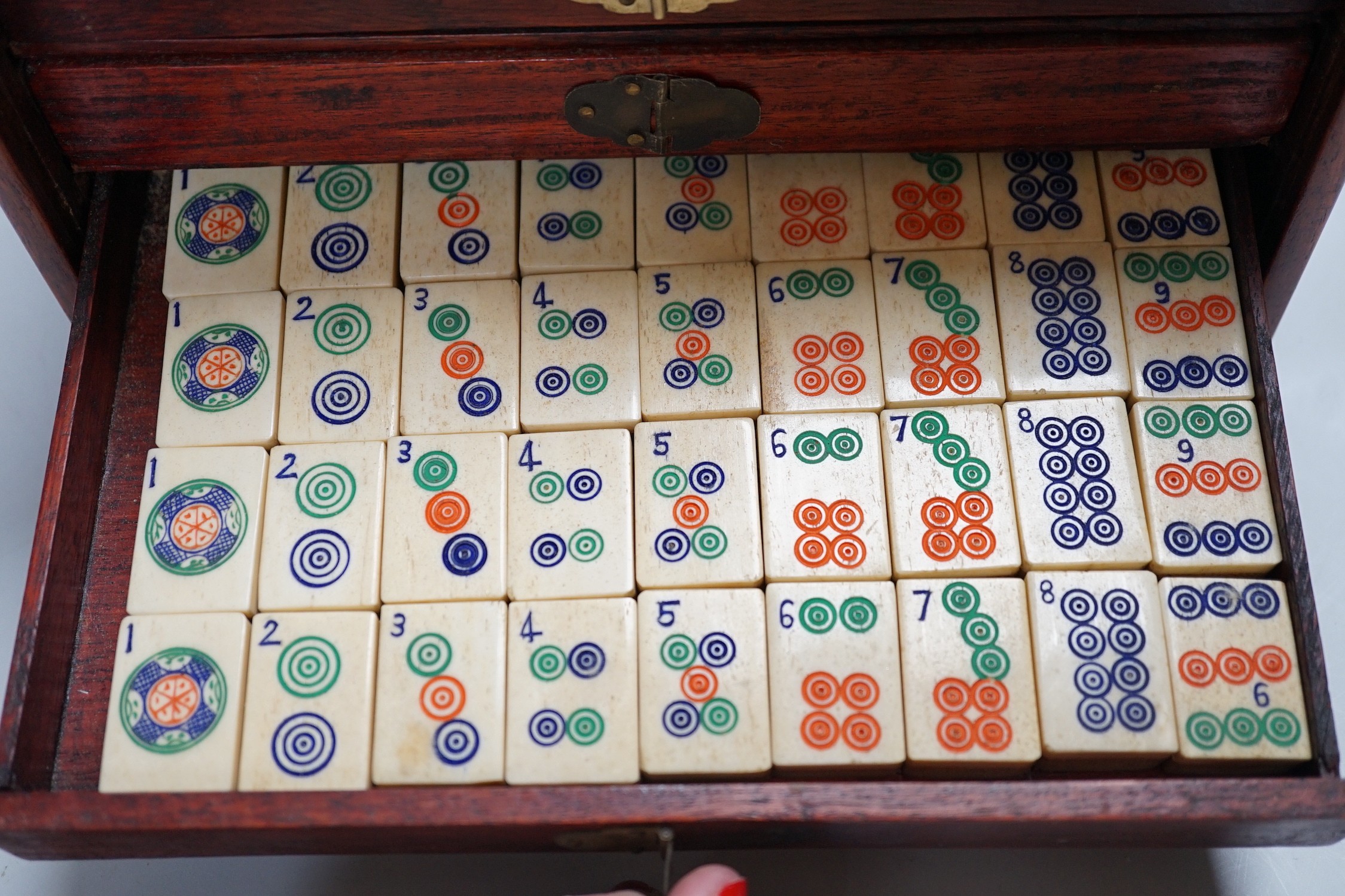 A Chinese Mah-Jong set in hardwood case with bone pieces